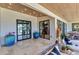 Covered patio featuring travertine floors, stylish decor, and views of the outdoor living and pool area at 810 Napoli Ln, Punta Gorda, FL 33950