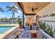 Stunning covered patio with outdoor furniture, pool, and waterfront views, ideal for enjoying the Florida lifestyle at 810 Napoli Ln, Punta Gorda, FL 33950