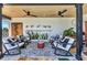 Charming outdoor patio featuring comfortable seating, plants, and a decorative rug at 810 Napoli Ln, Punta Gorda, FL 33950