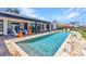 Luxurious backyard pool with stylish outdoor furniture, perfect for relaxing and entertaining at 810 Napoli Ln, Punta Gorda, FL 33950