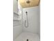 Modern shower featuring white tile, built-in shelving, a rainfall showerhead, and sleek design at 810 Napoli Ln, Punta Gorda, FL 33950