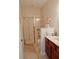 Bathroom with framed-glass shower and tiled walls, with marble-look flooring, neutral walls, and modern fixtures at 8233 Burwell Cir, Port Charlotte, FL 33981