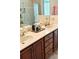 Bathroom vanity with double sinks, granite countertop, and framed mirror, next to tiled glass shower at 8233 Burwell Cir, Port Charlotte, FL 33981