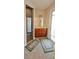 Bright bathroom with a wooden vanity, walk-in shower, tile flooring and neutral colored bath mats at 8233 Burwell Cir, Port Charlotte, FL 33981