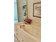 Bright bathroom featuring a marble-look bathtub next to the glass shower, decorated with flowers and artwork at 8233 Burwell Cir, Port Charlotte, FL 33981