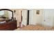 Bedroom featuring a large bed, hardwood floors, neutral walls, and tray ceiling at 8233 Burwell Cir, Port Charlotte, FL 33981