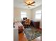 Bright bedroom with hardwood floors, a ceiling fan, two large windows, and neutral walls at 8233 Burwell Cir, Port Charlotte, FL 33981