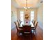 Formal dining room featuring a large table, seating for eight, and hardwood flooring at 8233 Burwell Cir, Port Charlotte, FL 33981