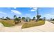 South Gulf Cove entry sign features sidewalks, lush lawns, and tropical trees at 8233 Burwell Cir, Port Charlotte, FL 33981