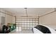 View of a garage door open with a white car partially shown in the foreground at 8233 Burwell Cir, Port Charlotte, FL 33981