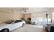 Spacious garage with white car, overhead storage, bicycles, and tool bench at 8233 Burwell Cir, Port Charlotte, FL 33981