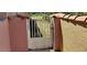 Private courtyard gate has textured wall, red tiled roof and features two palm trees on the white metal at 8233 Burwell Cir, Port Charlotte, FL 33981