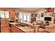 Open concept kitchen with wooden cabinets, granite countertops, island with seating, and stainless steel appliances at 8233 Burwell Cir, Port Charlotte, FL 33981