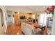 Spacious living room adjacent to kitchen features hardwood floors, neutral walls, and an abundance of natural light at 8233 Burwell Cir, Port Charlotte, FL 33981