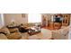 Cozy living room featuring hardwood floors, neutral walls, and comfortable seating at 8233 Burwell Cir, Port Charlotte, FL 33981