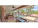 Relaxing screened patio with a lounge area overlooking a sparkling pool and lush landscaping at 8233 Burwell Cir, Port Charlotte, FL 33981
