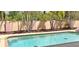 View of the pool and its surrounding hardscape and privacy wall at 8233 Burwell Cir, Port Charlotte, FL 33981