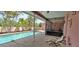 Beautiful backyard featuring a private pool, spa, covered patio, and lush tropical landscaping at 8233 Burwell Cir, Port Charlotte, FL 33981