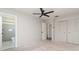 Bedroom with neutral paint, a ceiling fan, and an adjacent bathroom and closet at 8238 San Jacinto Ave, North Port, FL 34287