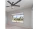 Bedroom featuring neutral paint, a ceiling fan, and a large window overlooking the backyard at 8238 San Jacinto Ave, North Port, FL 34287