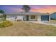Charming single-story home featuring a blue front door and a one-car garage at 8238 San Jacinto Ave, North Port, FL 34287