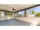 Enclosed lanai with vinyl flooring and a ceiling fan, providing additional living space with views of the backyard at 8238 San Jacinto Ave, North Port, FL 34287