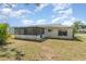 Rear exterior features a screened lanai, windows, and stucco walls at 8238 San Jacinto Ave, North Port, FL 34287