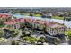 Stunning waterfront condo complex with mature landscaping, red tile roof, and ample parking at 98 Vivante Blvd # 9834, Punta Gorda, FL 33950