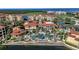 Aerial view of an upscale community with lush landscaping, swimming pool, and waterway at 98 Vivante Blvd # 9834, Punta Gorda, FL 33950