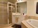 Elegant bathroom featuring a glass-enclosed shower, soaking tub and well-lit vanity at 98 Vivante Blvd # 9834, Punta Gorda, FL 33950