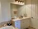 Bright bathroom features a vanity with storage, a large mirror, and decorative lighting at 98 Vivante Blvd # 9834, Punta Gorda, FL 33950