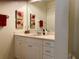 Well-lit bathroom with single sink vanity, mirror and decorative accents at 98 Vivante Blvd # 9834, Punta Gorda, FL 33950