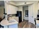 Well-lit kitchen with white cabinetry, modern backsplash, and stainless steel appliances at 98 Vivante Blvd # 9834, Punta Gorda, FL 33950