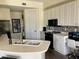 Modern kitchen features white cabinetry, a breakfast bar, and stainless steel appliances at 98 Vivante Blvd # 9834, Punta Gorda, FL 33950