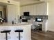 Bright kitchen featuring ample white cabinetry, stainless steel appliances and a breakfast bar for casual dining at 98 Vivante Blvd # 9834, Punta Gorda, FL 33950
