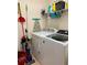 Functional laundry room with washer, dryer, and ample storage shelving at 98 Vivante Blvd # 9834, Punta Gorda, FL 33950
