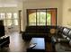 Spacious living room boasts dark laminate floors, comfortable sofa, and access to a private balcony at 98 Vivante Blvd # 9834, Punta Gorda, FL 33950