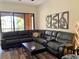 A contemporary living room featuring a large sectional, stylish artwork, and access to balcony at 98 Vivante Blvd # 9834, Punta Gorda, FL 33950