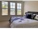 Inviting bedroom with large windows with neighborhood views and stylish bedding for comfortable living at 98 Vivante Blvd # 9834, Punta Gorda, FL 33950