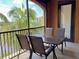 Relaxing screened patio features a dining table with seating for outdoor dining and serene views at 98 Vivante Blvd # 9834, Punta Gorda, FL 33950