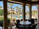 A stunning pool view from the covered patio with outdoor seating, tall palm trees, and resort-style amenities at 98 Vivante Blvd # 9834, Punta Gorda, FL 33950
