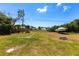 Expansive backyard featuring green grass and a boat on a trailer at 11105 Pendleton Ave, Englewood, FL 34224