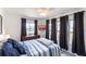 Comfortable bedroom with a flat screen TV and large window with curtains at 11105 Pendleton Ave, Englewood, FL 34224