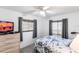 Comfortable bedroom with ceiling fan and natural light from two windows at 11105 Pendleton Ave, Englewood, FL 34224