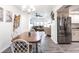 Dining room with wood floors, white walls, wicker chairs, leading into a living room at 11105 Pendleton Ave, Englewood, FL 34224