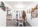 Dining room with wood floors, white walls, wicker chairs, and a view into the kitchen and outdoor patio at 11105 Pendleton Ave, Englewood, FL 34224