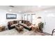 Comfortable living room with lots of windows, neutral tones, stylish decor, and wood-look floors at 11105 Pendleton Ave, Englewood, FL 34224
