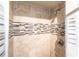 Tiled shower stall with rainfall shower head and decorative accent stripe at 11105 Pendleton Ave, Englewood, FL 34224