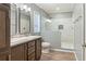 Modern bathroom featuring double sinks, a glass-enclosed shower, and modern fixtures at 11136 Grapefruit Ln, Punta Gorda, FL 33955