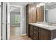 Bathroom showcasing double sinks and entry to bedroom space at 11136 Grapefruit Ln, Punta Gorda, FL 33955